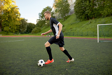 Image showing soccer player playing with ball on football field