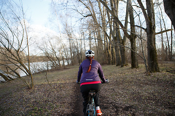 Image showing Sportswoman rides bicycle at park