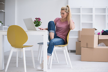 Image showing Young woman moving in a new home