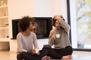 Image showing multiethnic couple  in front of fireplace