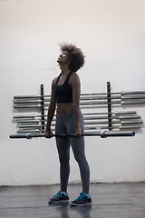 Image showing black woman lifting empty bar