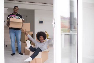 Image showing African American couple  playing with packing material