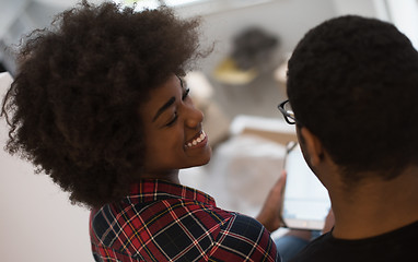 Image showing african american couple using tablet at home