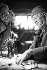 Image showing Man with sewing machine bw