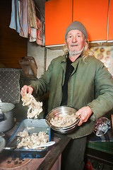 Image showing Man preparing pork for lunch