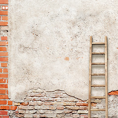 Image showing weathered stucco wall with wooden ladder