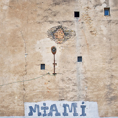 Image showing cracked brick wall with graffiti