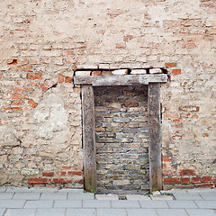 Image showing cracked brick wall with bricked up doorway