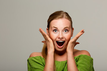 Image showing Surprised woman in green sweater