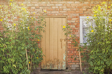 Image showing red brick wall and wooden door