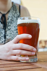 Image showing hand holding glass of beer