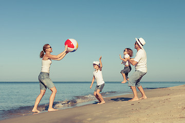 Image showing Happy family playing on the beach at the day time.