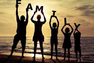 Image showing Happy family standing on the beach