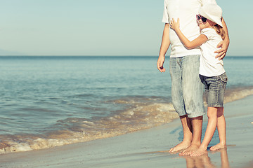 Image showing Father and daughter playing on the beach.