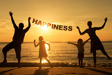 Image showing Happy family standing on the beach