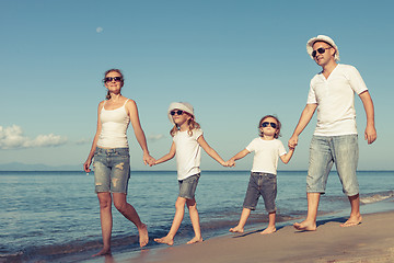 Image showing Happy family standing on the beach at the day time.