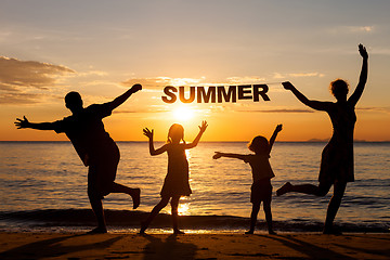 Image showing Happy family standing on the beach