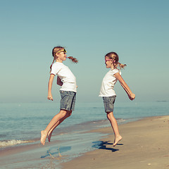 Image showing two sisters playing on the beach