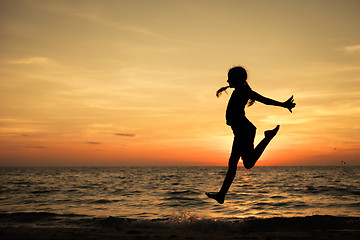 Image showing Happy teen girl  jumping on the beach