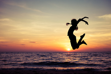 Image showing Happy teen girl  jumping on the beach