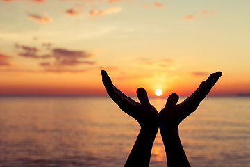 Image showing silhouette of female hands during sunset