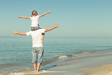 Image showing Father and daughter playing on the beach.