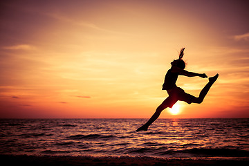 Image showing Happy teen girl  jumping on the beach