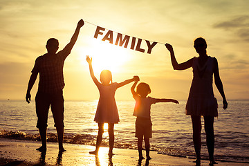 Image showing Happy family standing on the beach