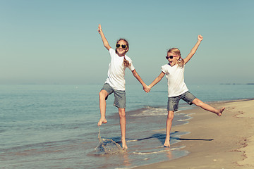 Image showing two sisters playing on the beach