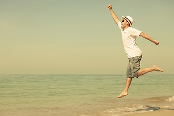 Image showing Happy man jumping on the beach