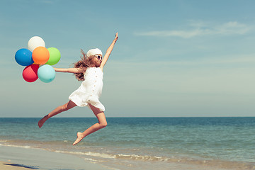 Image showing Teen girl  jumping on the beach