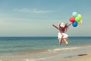 Image showing Teen girl  jumping on the beach