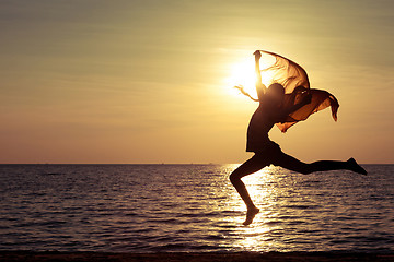 Image showing Happy girl jumping on the beach