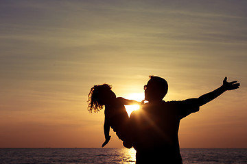 Image showing Father and son playing on the beach