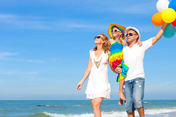 Image showing Happy family playing  with balloons on the beach at the day time