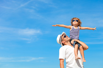 Image showing Father and son playing on the beach at the day time.