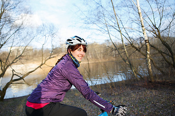 Image showing Woman rides bicycle at park