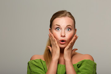 Image showing Surprised girl in green sweater