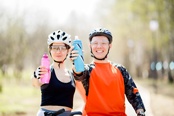 Image showing Cyclists with bottles of water