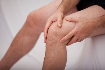 Image showing Man holding his knee