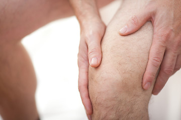 Image showing Man holding his knee