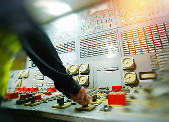 Image showing Hand on the control panel of a power plant