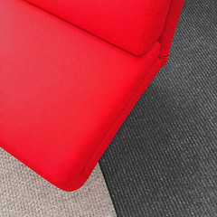 Image showing Vibrant soft red chair on gray carpet