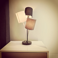 Image showing Retro style lamp on a dresser
