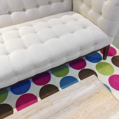 Image showing Elegant white sofa on a bright rug