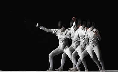 Image showing Full-length portrait of woman wearing white fencing costume on black