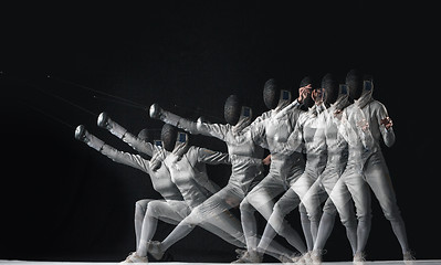 Image showing Full-length portrait of woman wearing white fencing costume on black