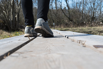 Image showing Walking on a wooden footpath