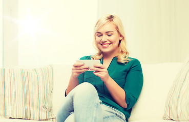 Image showing happy woman with smartphone at home