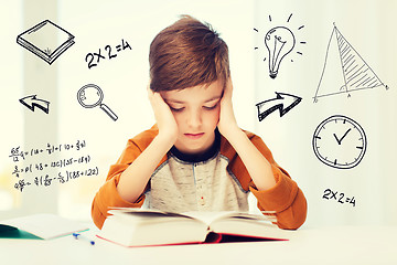 Image showing student boy reading book or textbook at home